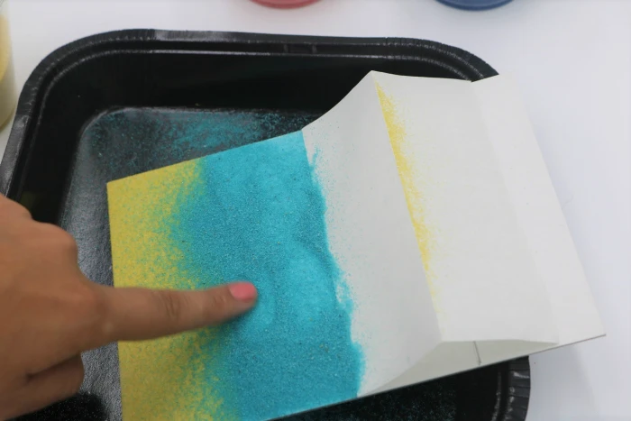 It's easy to create beautiful sand art with adhesive boards.